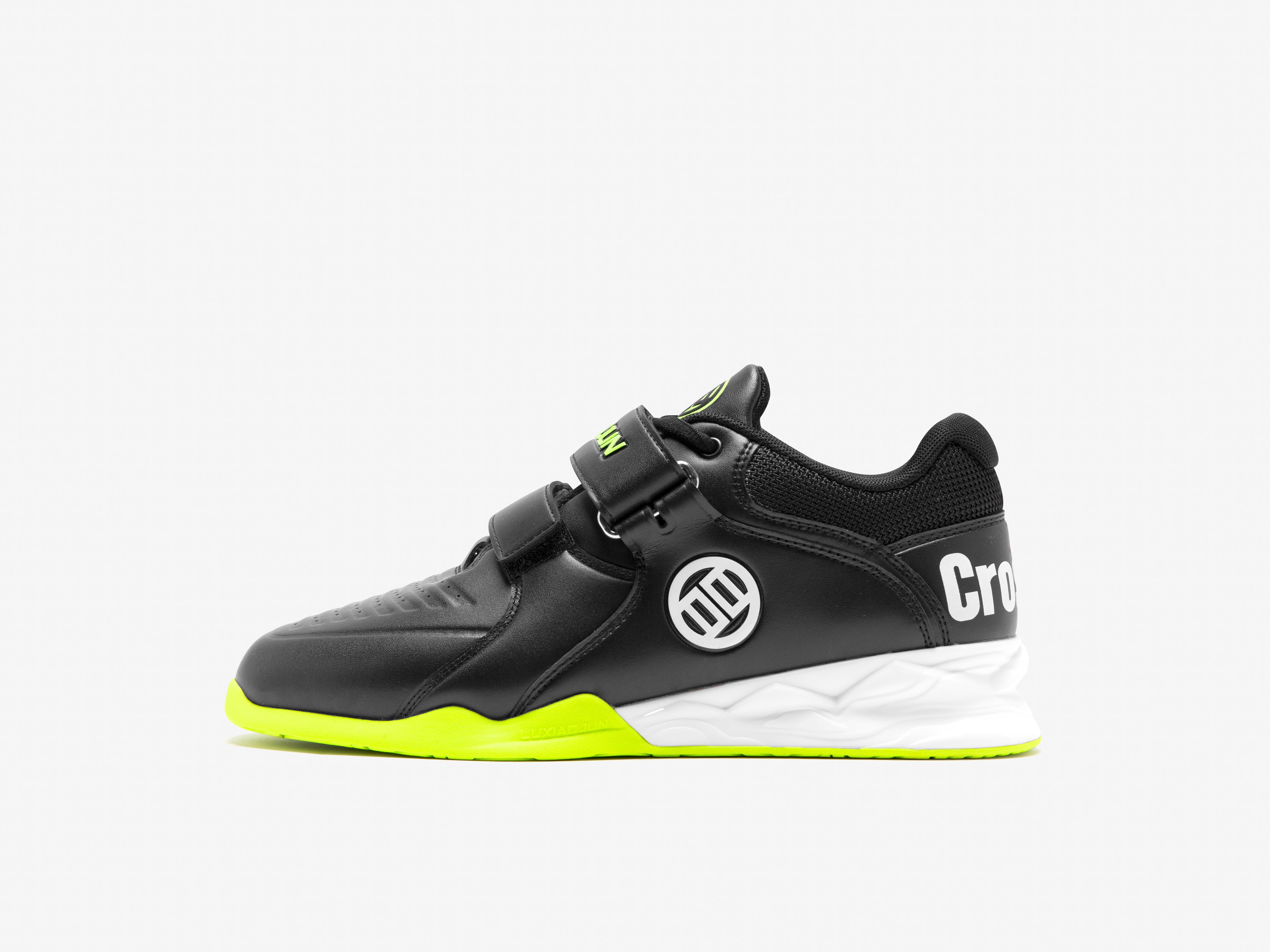 Black and green athletic shoe with a visible brand logo on a white background
