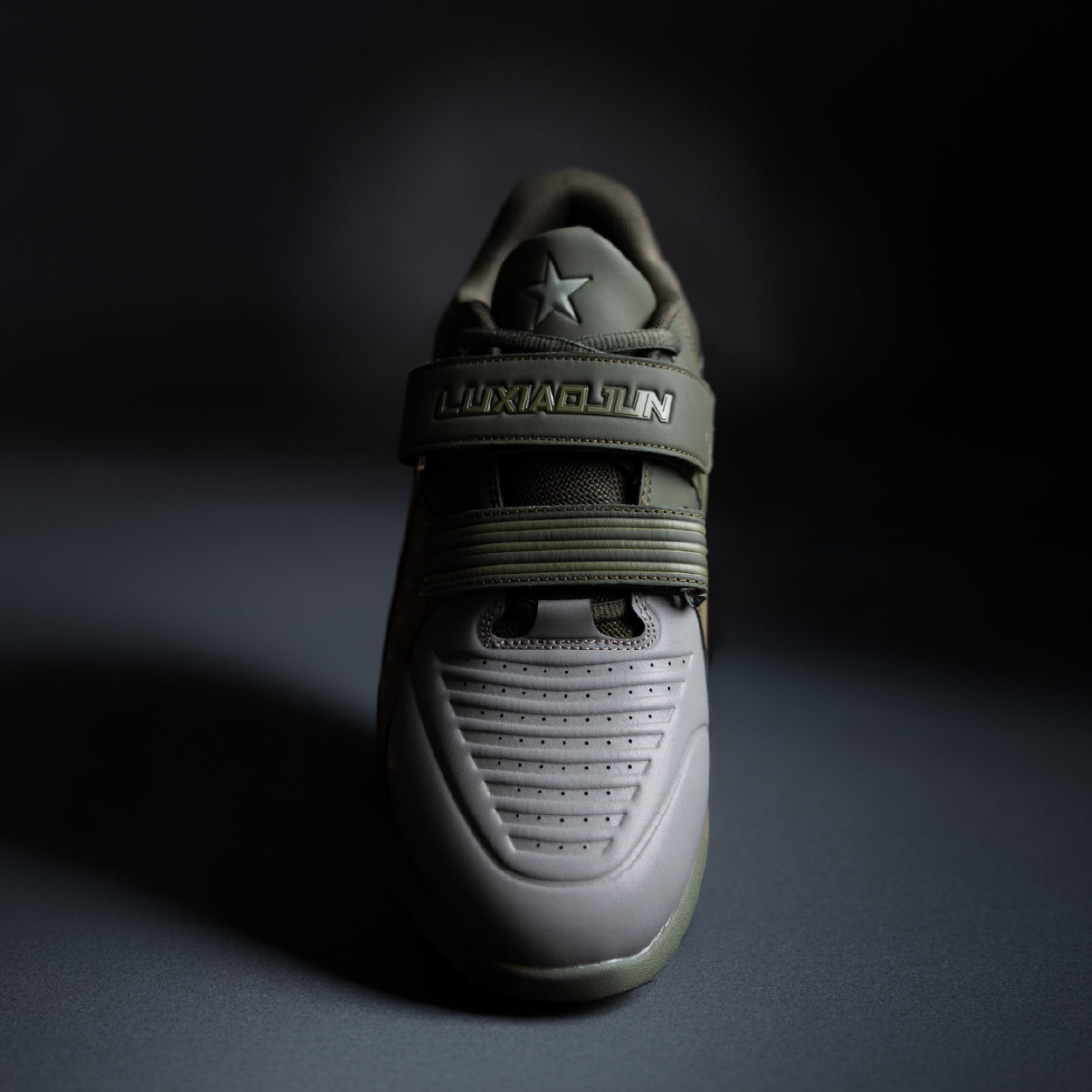 Green athletic shoe with brand logo on a dark background