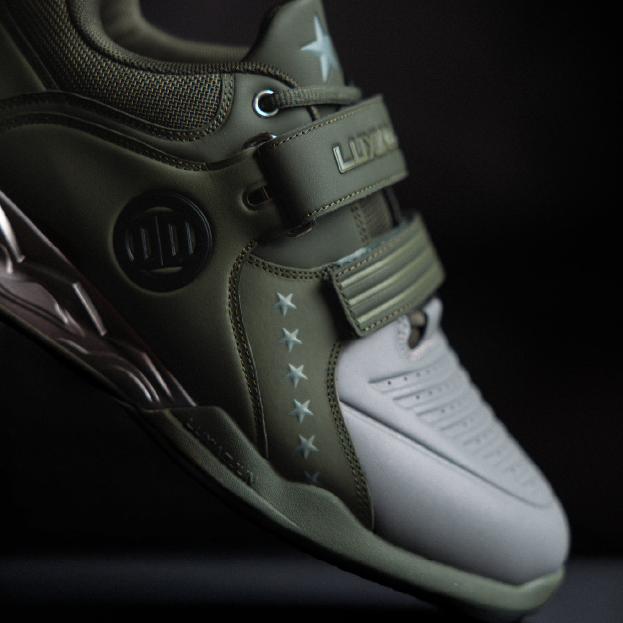 Close-up of a green and white sneaker with visible branding on a dark background