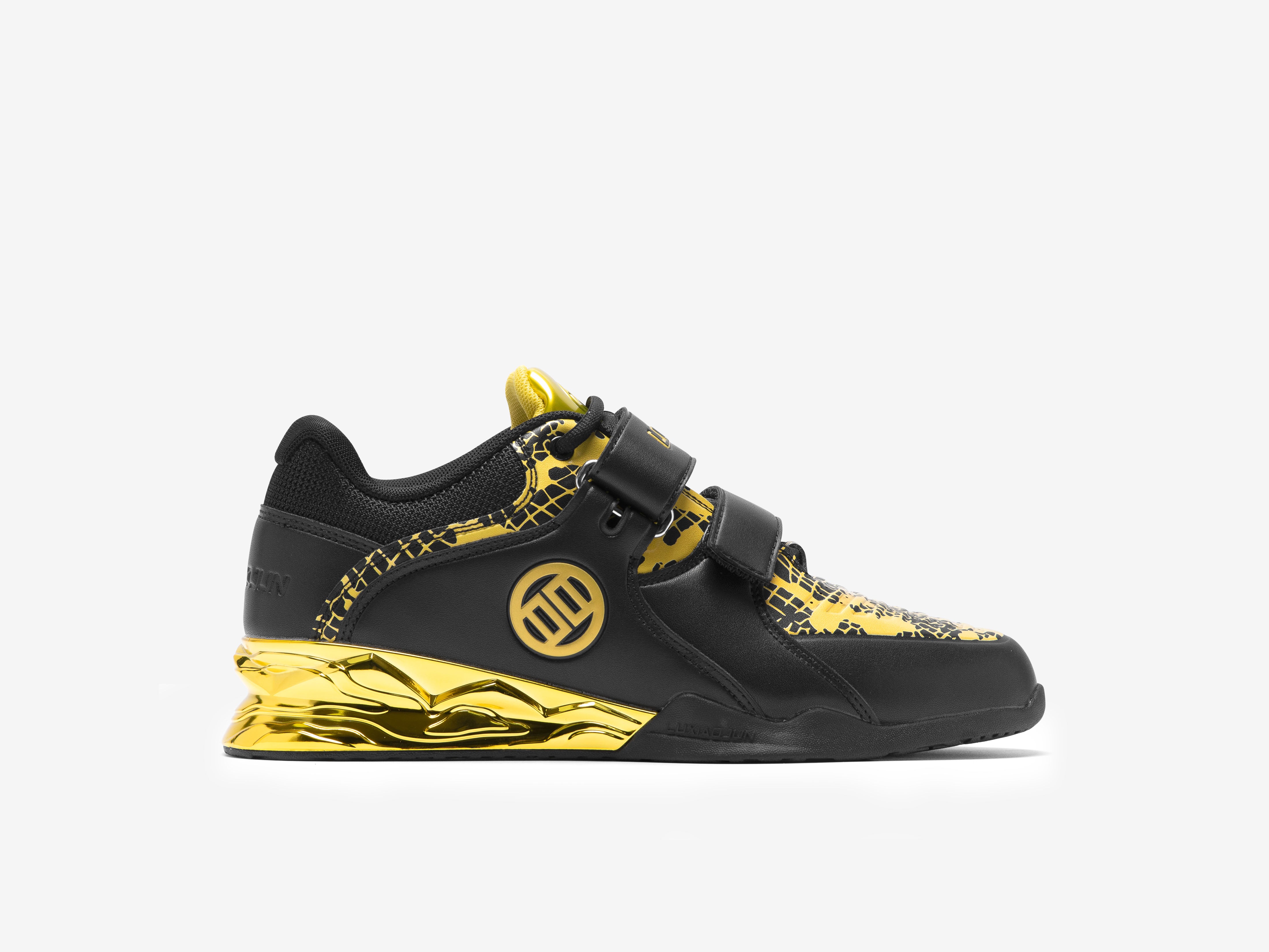 The outer side of the right side of the black and gold limited edition weightlifting shoes on a white background