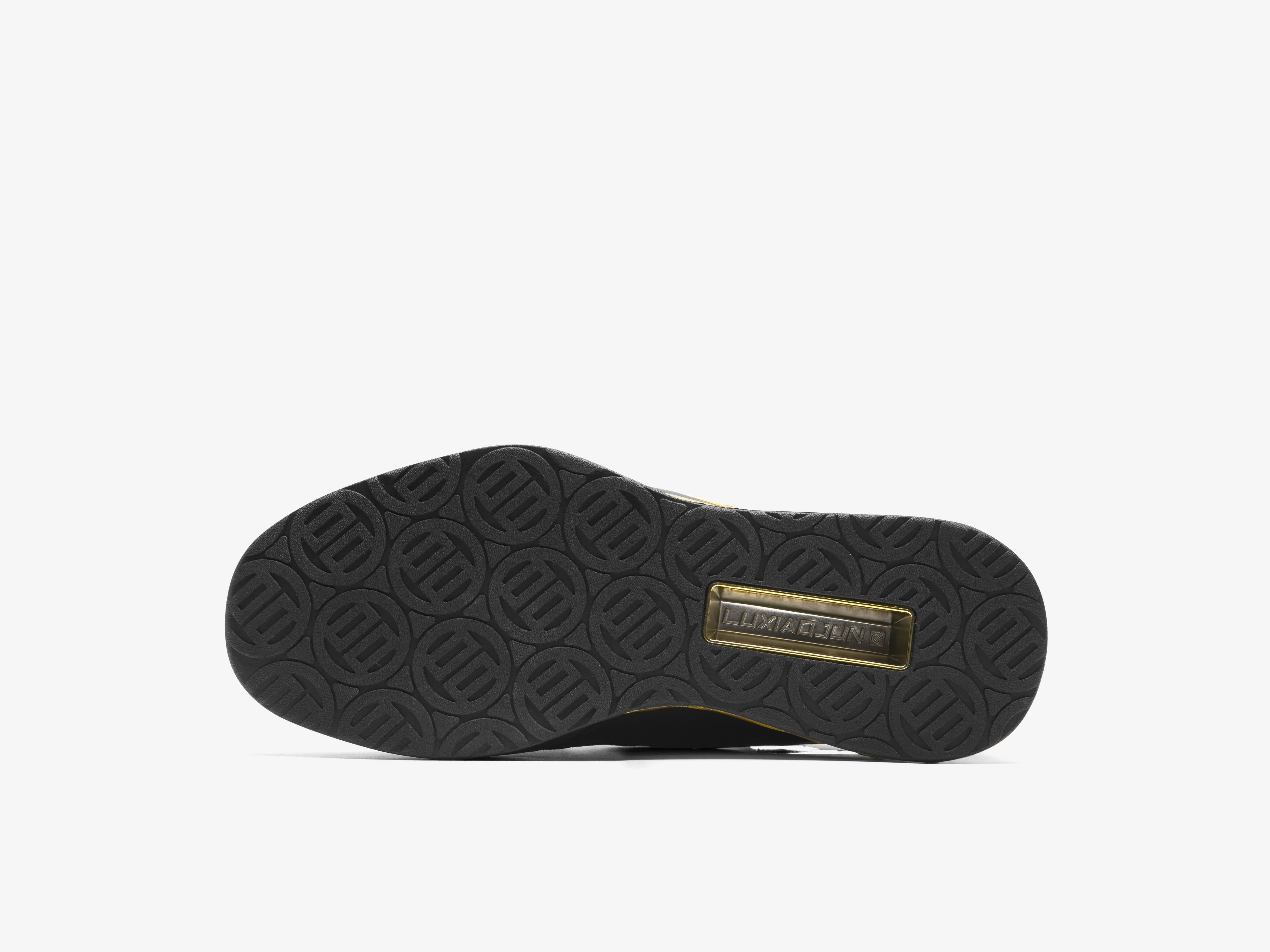 The sole of the black and gold the year of snake edition weightlifting shoes on a white background