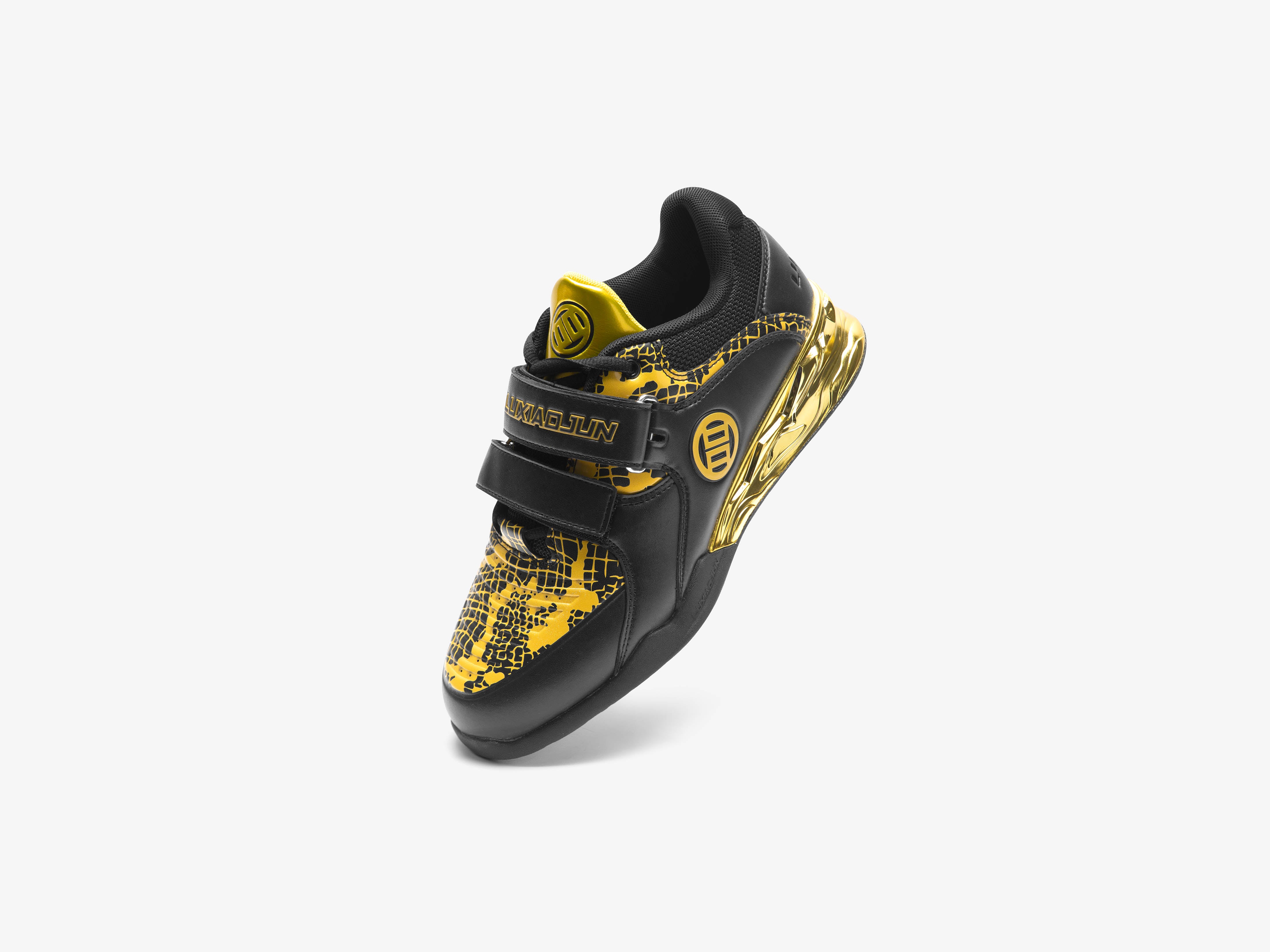 Standing view of the black and gold snake edition weightlifting shoes on a white background
