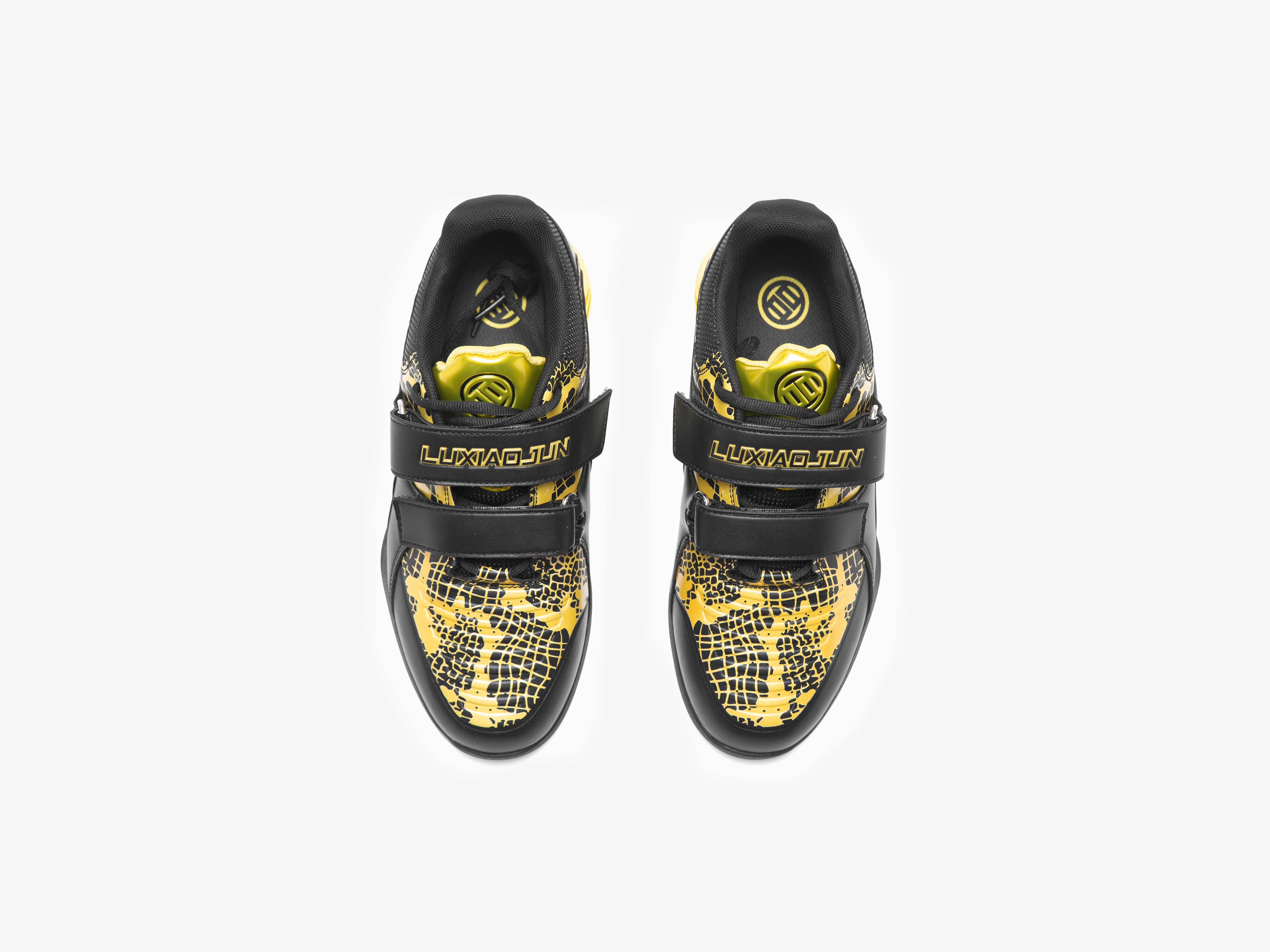 The top view of the year of snake edition black and gold weightlifting shoes on a white background