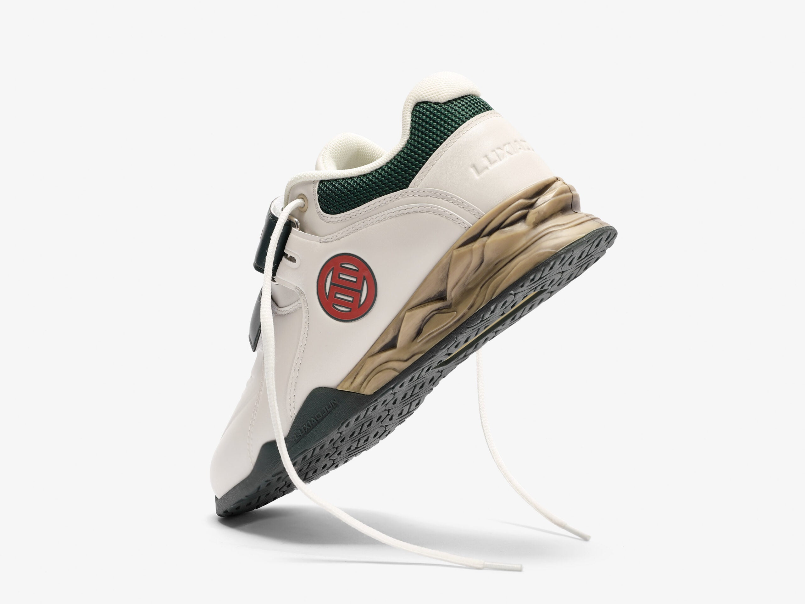 The standing view of the distressed white and green weightlifting shoes with shoe laces untied on a white background