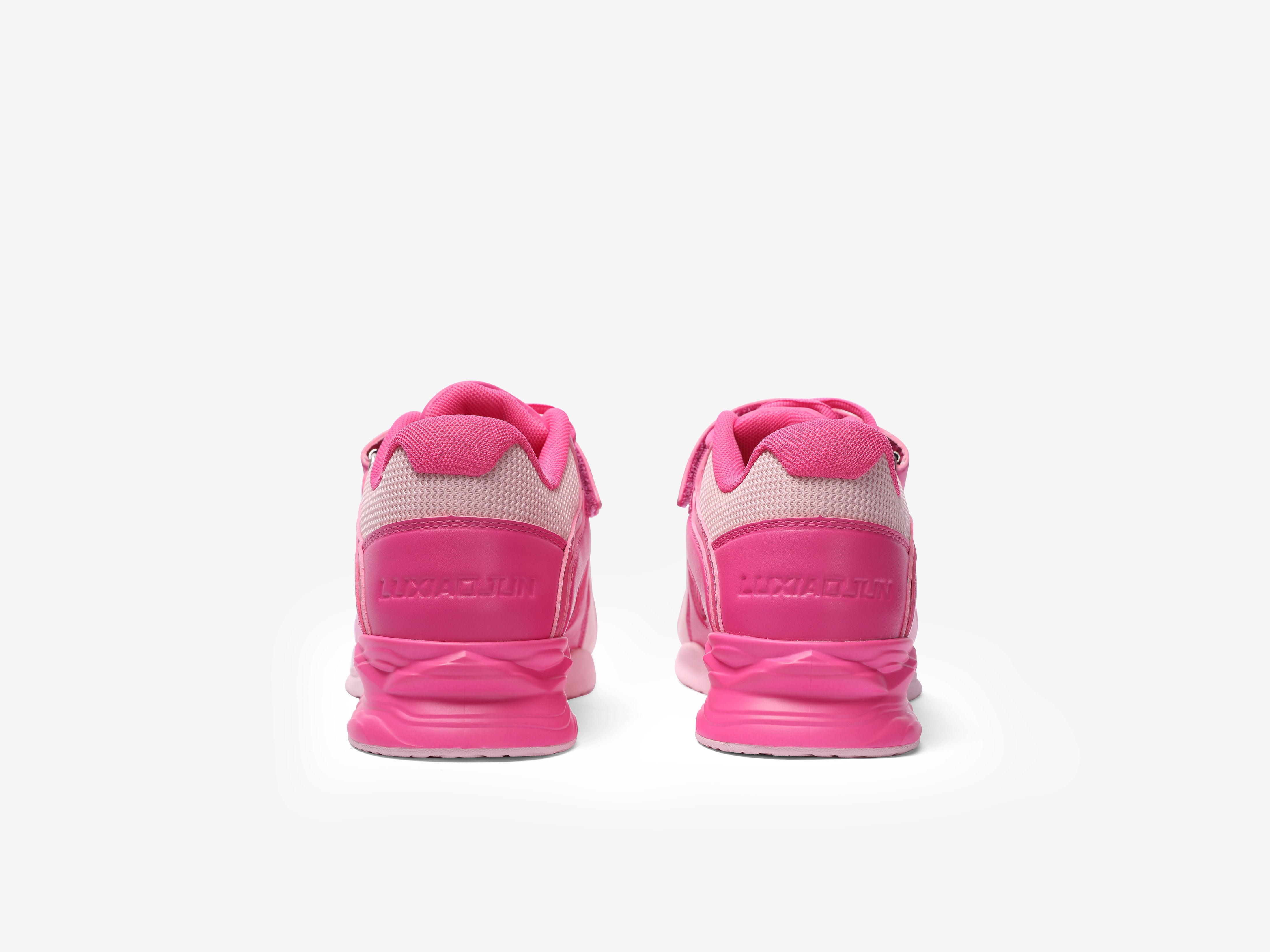 The backside of the rose weightlifting shoes with white accents on a white background