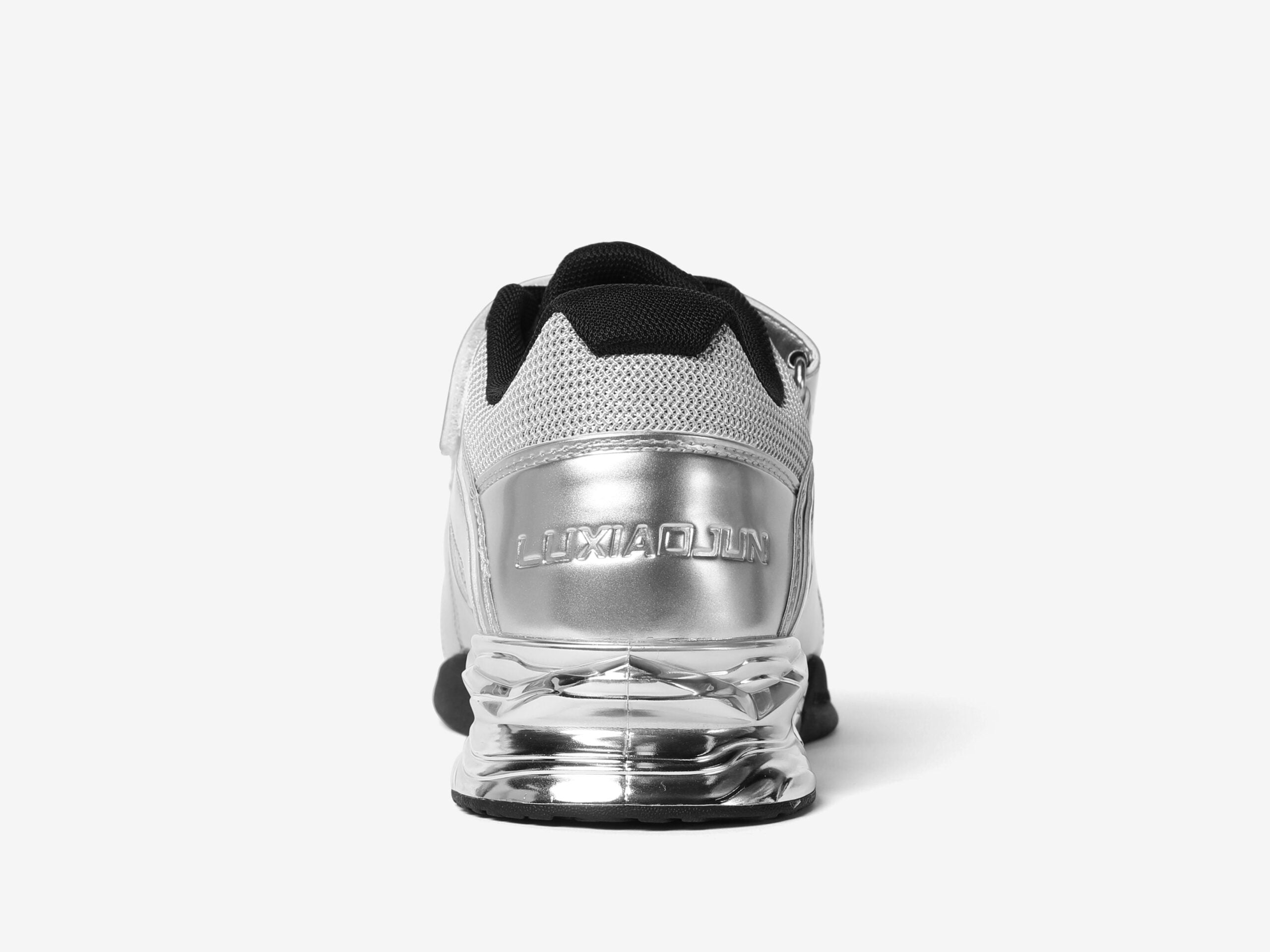 Heel side of the silver weightlifting shoes that says luxiaojun