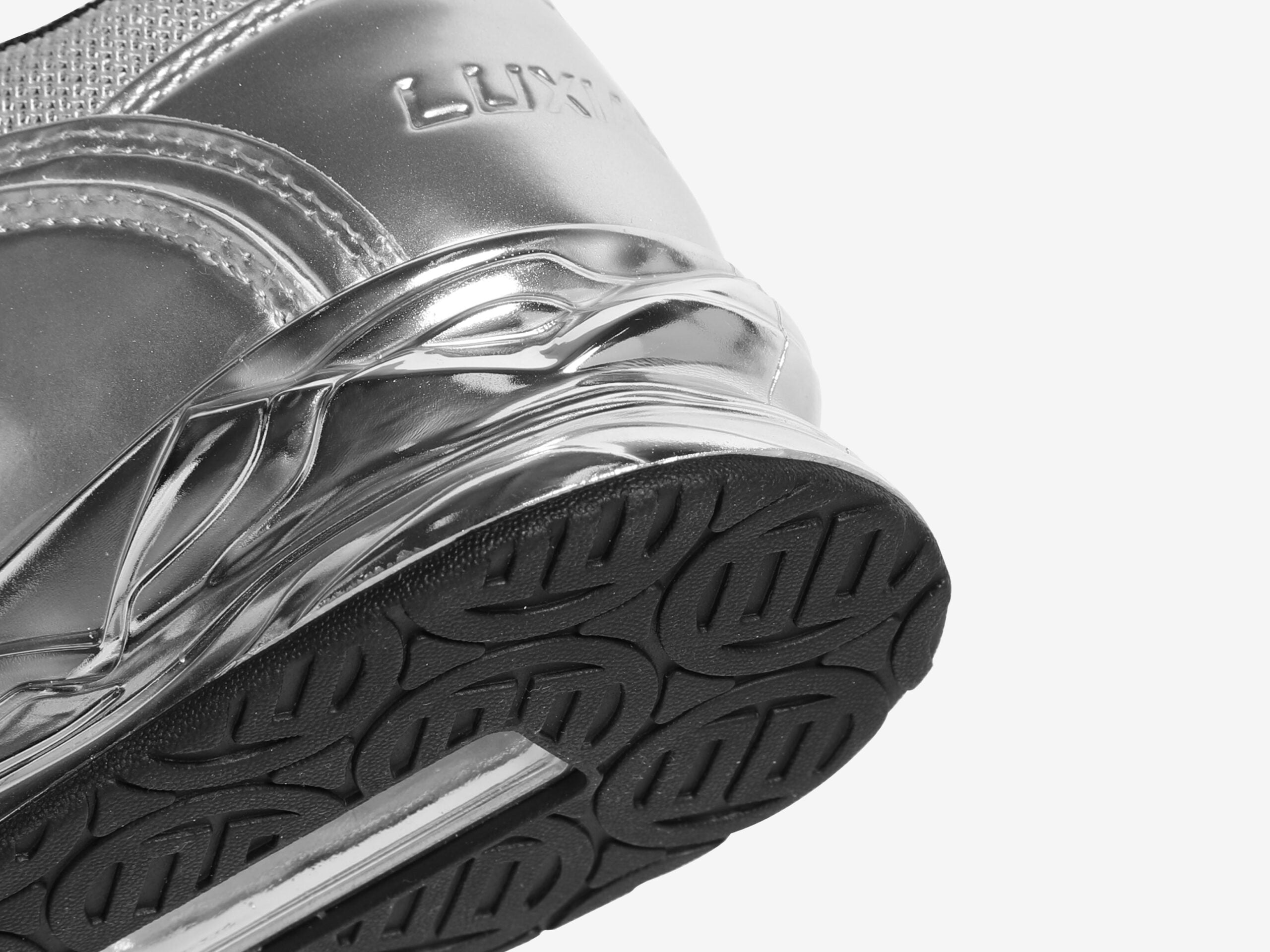 Close up shot of the heel of silver weightlifting shoes by luxiaojun on a white background