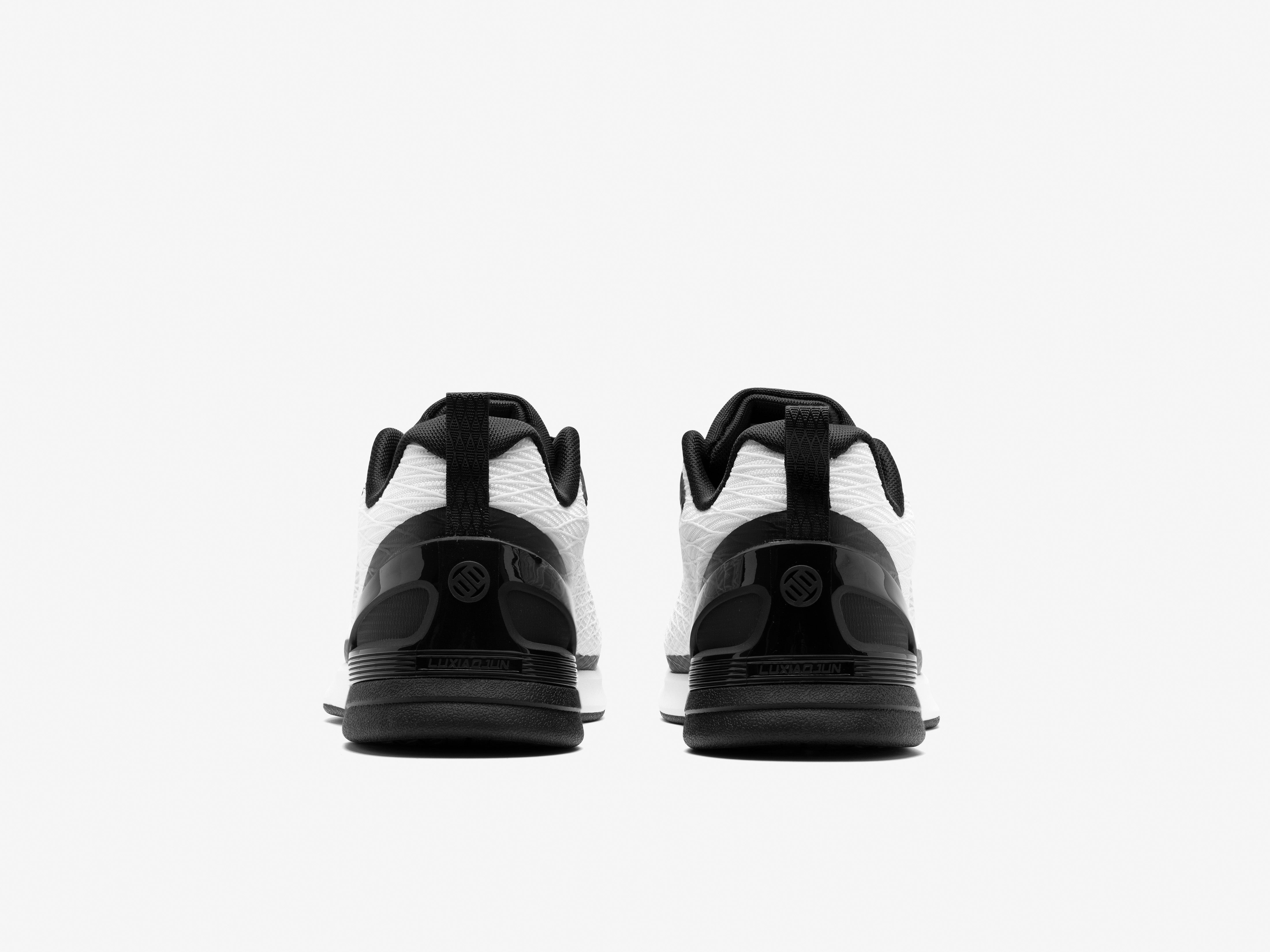 Black and white athletic shoes on a light gray background