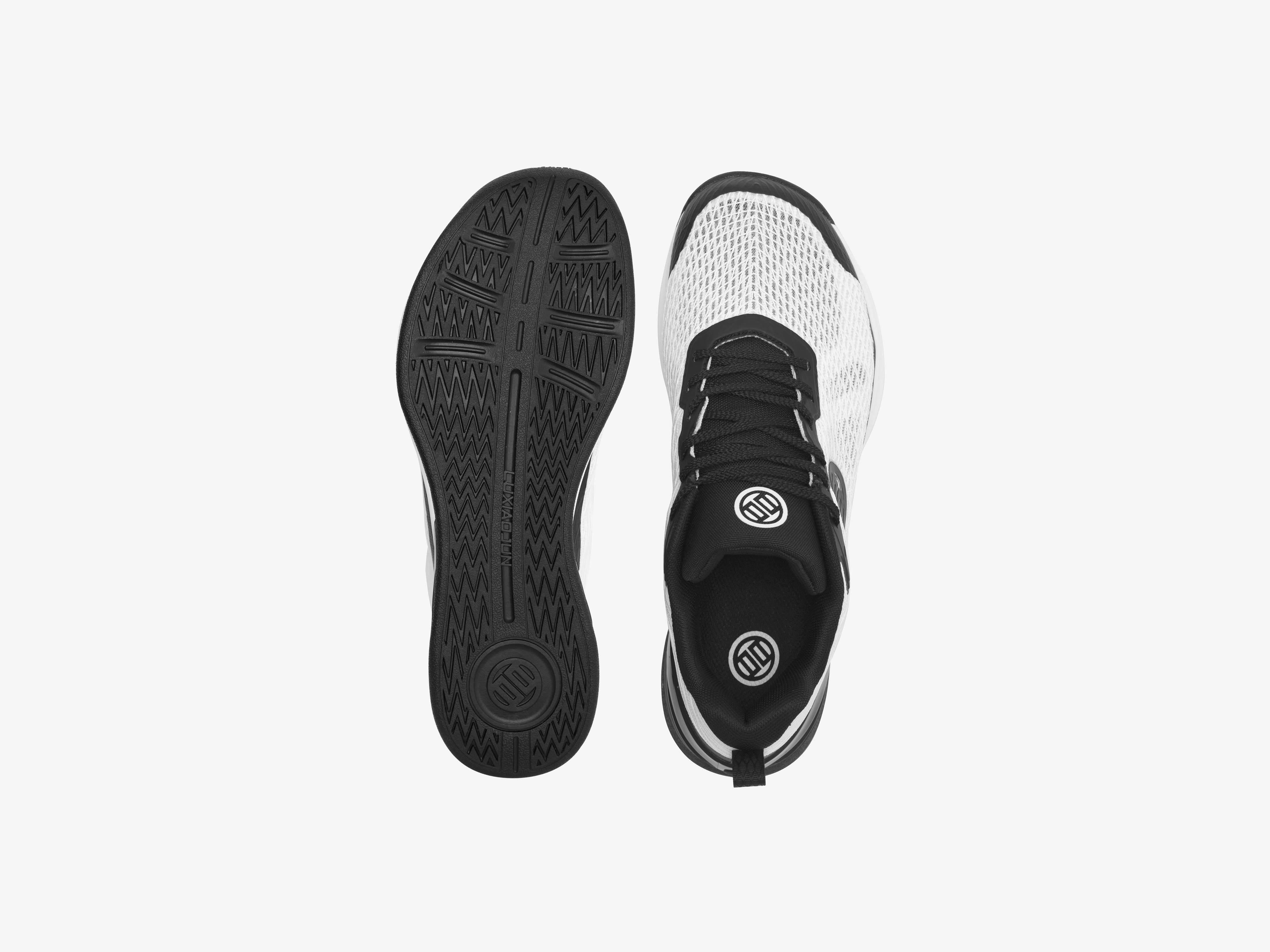 Black and white athletic shoes on a light gray background