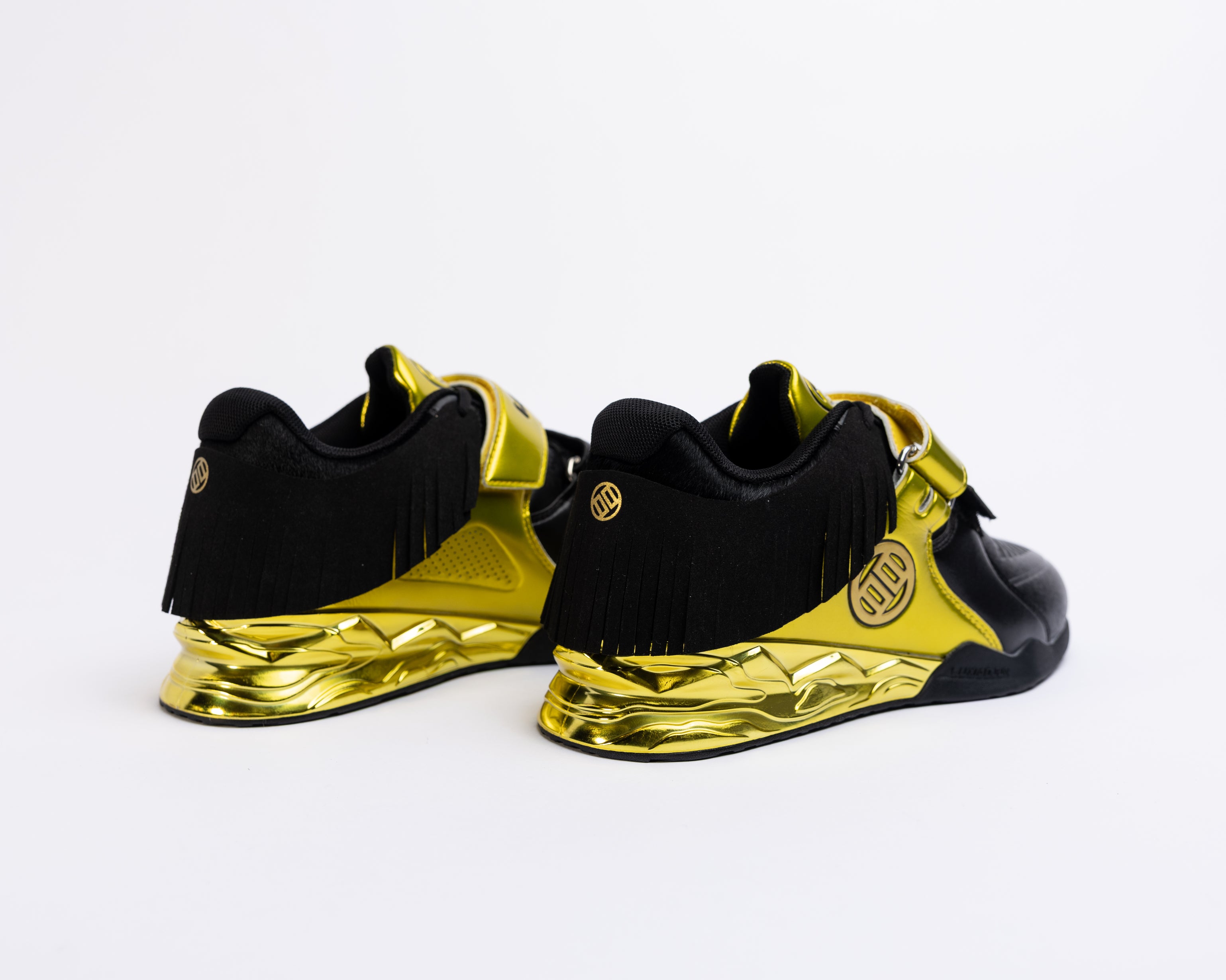 Black and gold sneakers on a white background