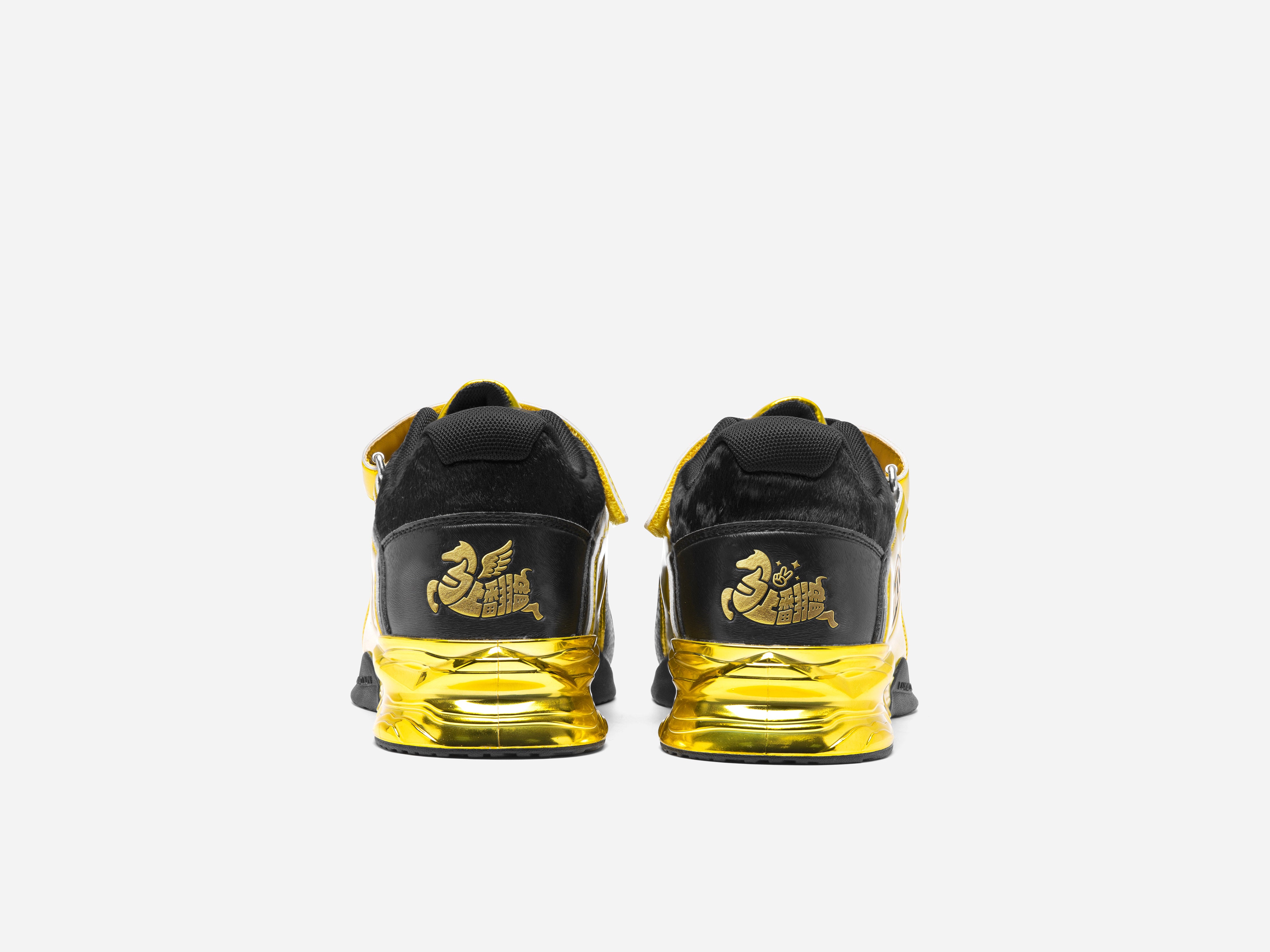 Black and yellow sneakers with gold accents on a white background