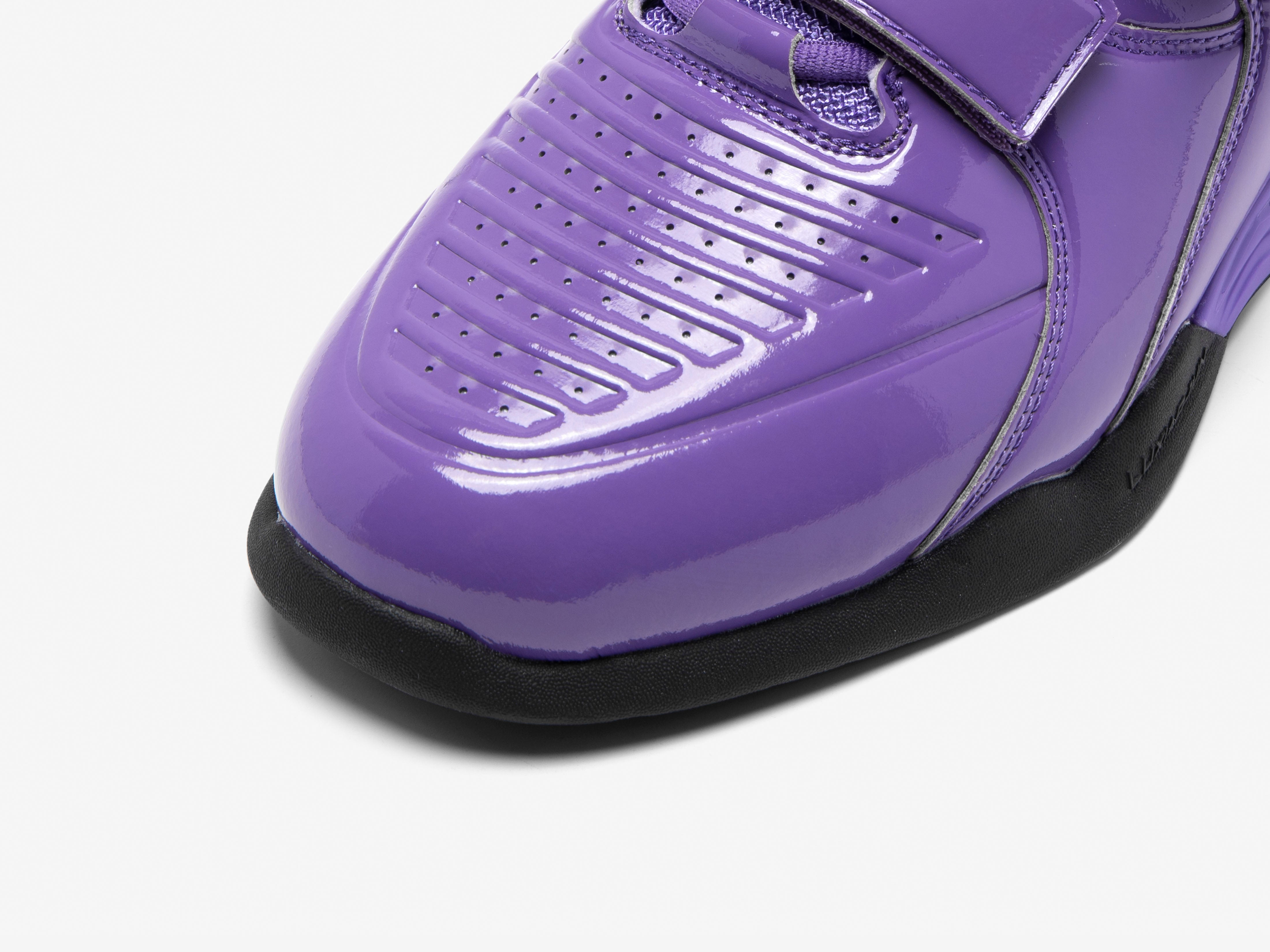 Purple athletic squat lifting shoe with a black sole on a white background
