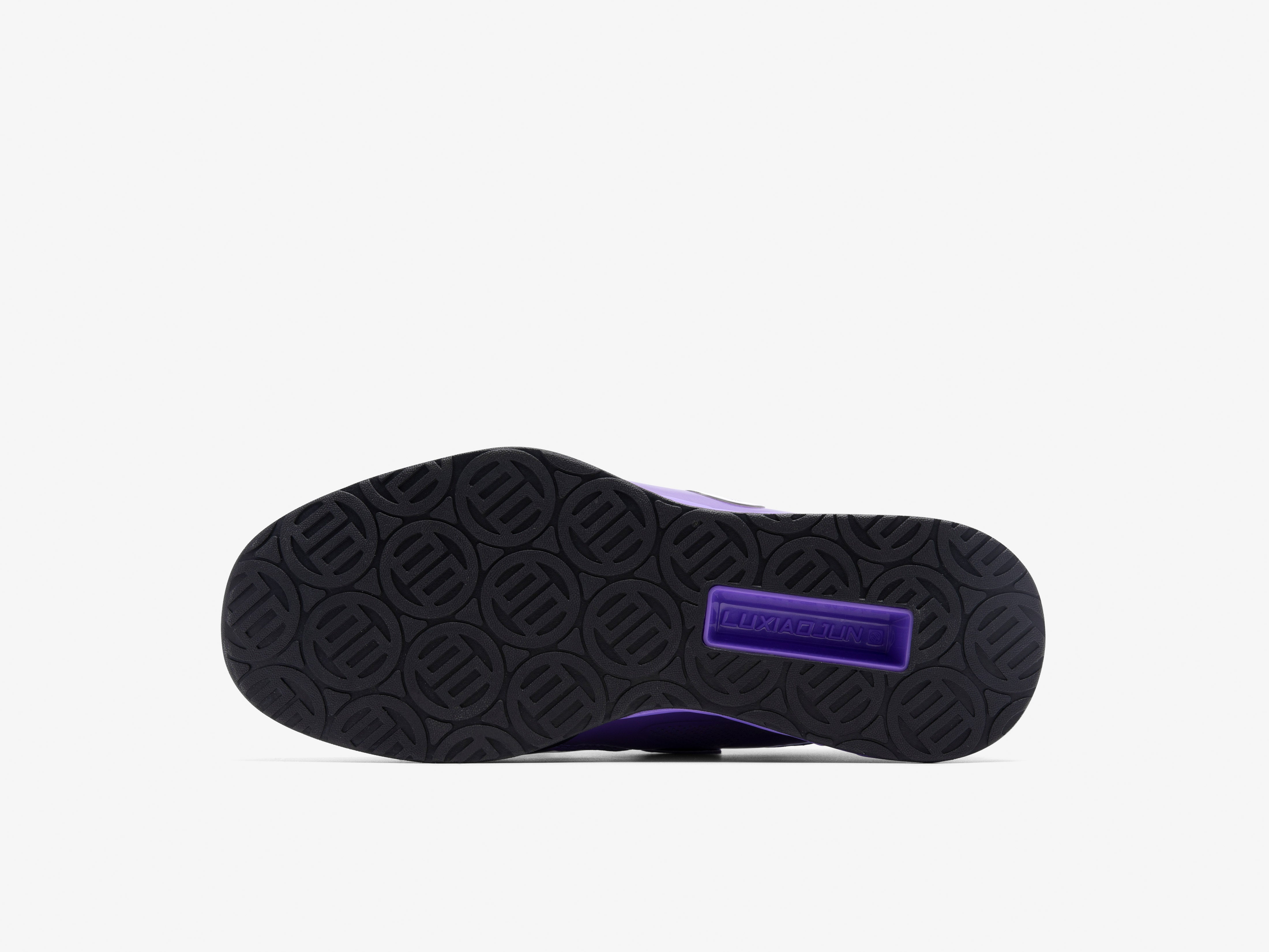 Black shoe sole with a purple label on a white background