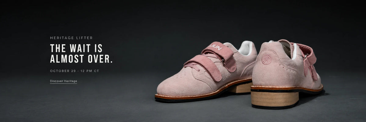 Heritage Lifter. The Wait Is Almost Over. October 29, 12 PM CT. A pair of pink Heritage Lifters on a dark studio floor.