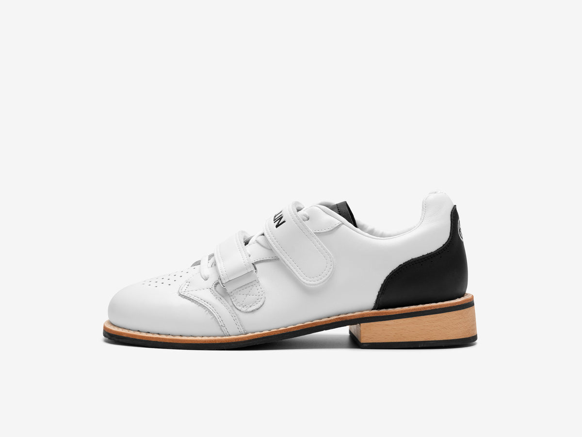 Side view of the white Heritage Lifter with a black heel panel, two white straps and a beechwood heel