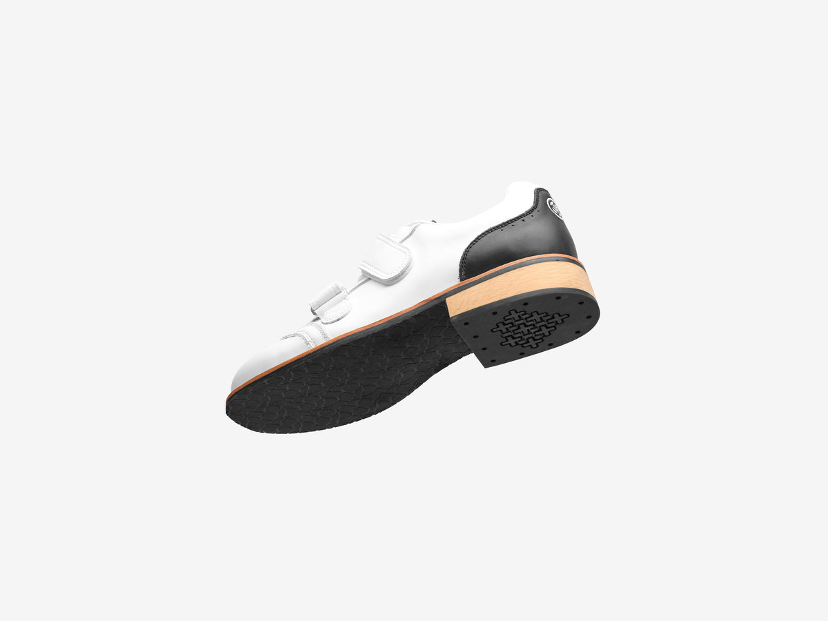 White Heritage Lifter tilted to show the outsole tread and the edge of the beechwood heel