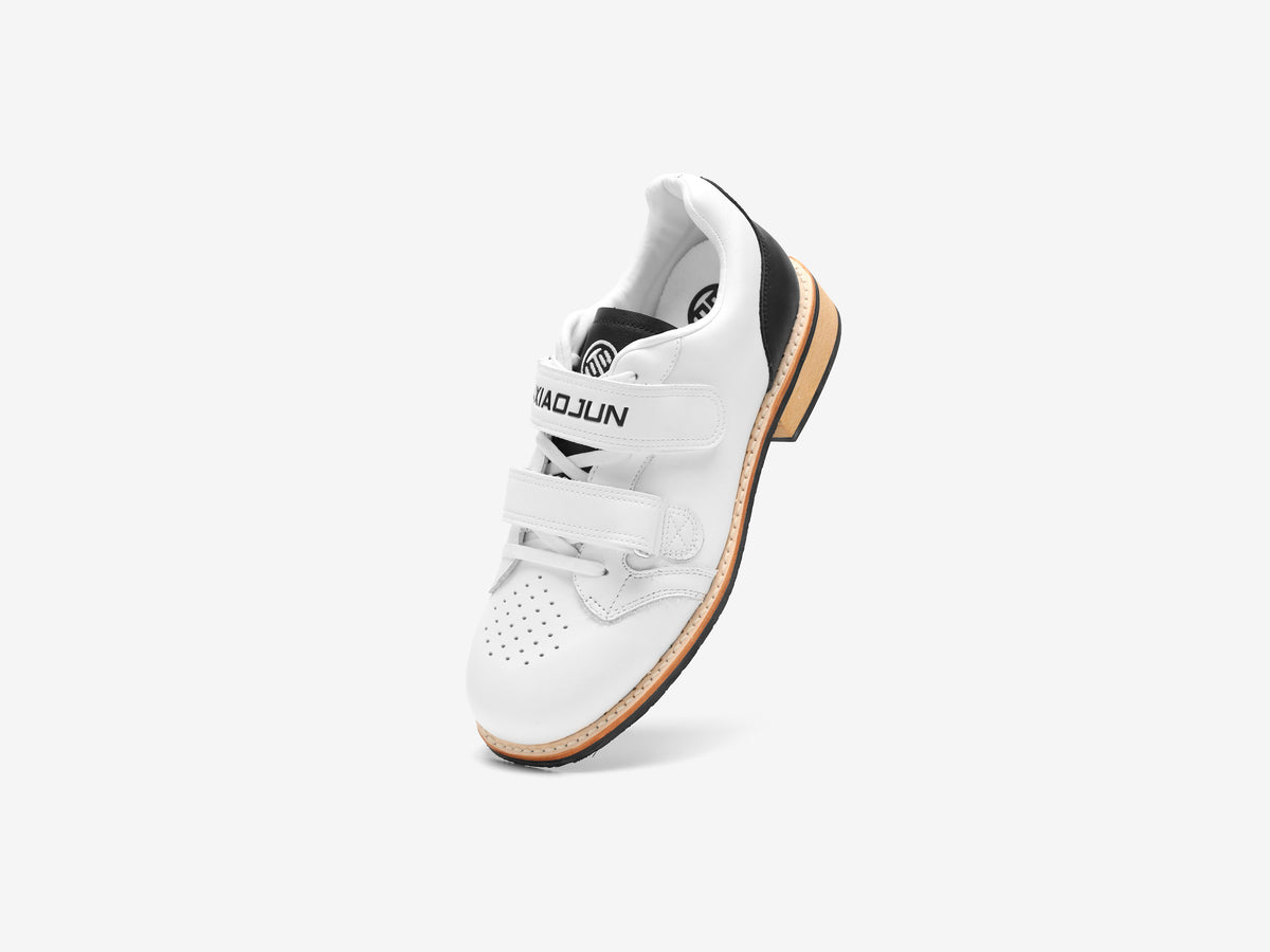 Top view of the white Heritage Lifter showing the LUXIAOJUN strap, laces and perforated toe